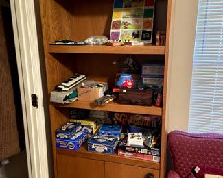 Nice shelf unit with storage. Several sets of dominoes, and other games.