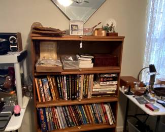 Nice glass drop front shelf unit. Lots of boxes, gun and knife catalogs.