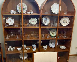 Two matching arched teak curio cabinets.  Priced separate