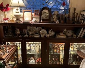 There are many smaller pieces of interest in this photo: clocks, candlesticks, lamps, dishware, and more.