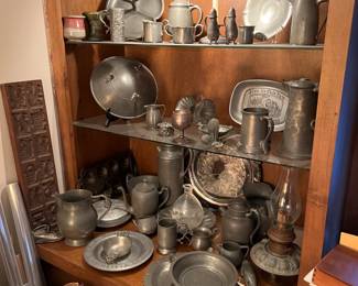All of these dishes and serving pieces are made with pewter.  This is a nice collection.