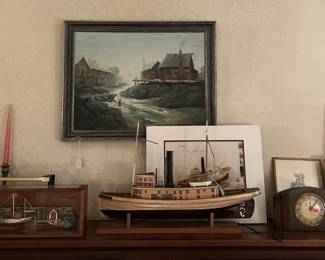 This photo shows two sets of candlesticks, a model steamship, a framed painting, and more.