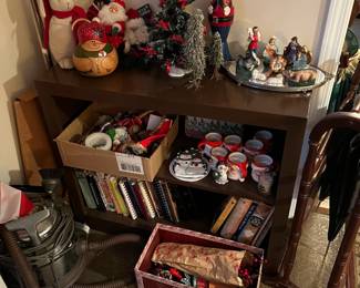 There are a couple of vacuum cleaners in the sale; the left of this photo shows one of them.  There are also some end-of-the year holiday decorations.  A portion of a blanket rack can be seen on the right.