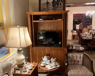 Prime among the items here is the entertainment center, behind the chair, sofa, side tables, and lamp.  