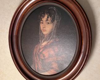 This oval-framed portrait shows a young woman from a different era.