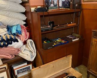 The telescope at the bottom of the picture is a Bushnell Banner Astro.  Look closely on the middle shelf and you can see a weaving loom shuttle, and a musical recorder behind it.  There are a number of Matchbox or Hot Wheels model cars, too.