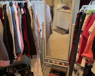 This photo shows the floor mirror and parts of the two racks of clothing.