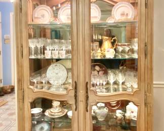 Beveled glass lighted whitewashed carved pine cabinet