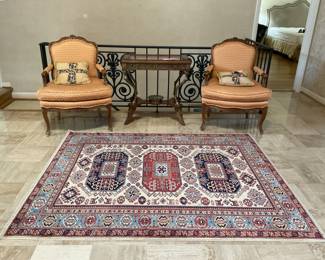 Pair of Baker Chairs with a gorgeous display table in between chairs. 