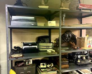 sears typewriter, polaroid camera, carved wood, westinghouse fan, turntable, insulators, singer pheonix sewing machine, john wayne plaque, vintage microphone, 