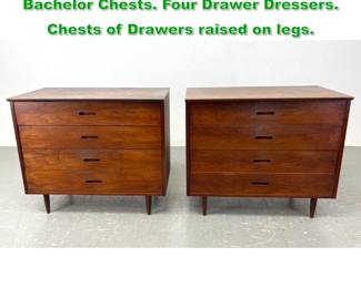 Lot 1131 Pr American Modern Walnut Bachelor Chests. Four Drawer Dressers. Chests of Drawers raised on legs. 