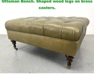 Lot 1383 Leather Chesterfield Oversized Ottoman Bench. Shaped wood legs on brass casters. 
