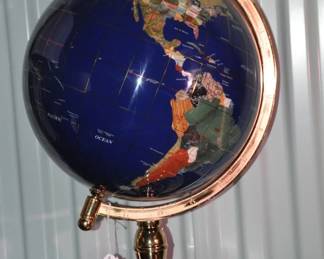 A Timeless Piece in Any Setting, This World Globe Features Inlaid Semi-Precious Gemstone Throughout Giving The Surface a Multitude of Bright Colors.  You Will Additionally Appreciate the Complimentary Brass Stand. 20"H,  ($65).