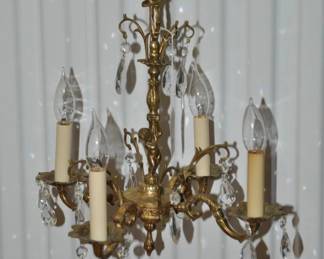 Antique Carved And Scrolled 4-Arm Chandelier Featuring Bronze Hardware and Crystal Drops Made in Spain, Sold "As Is" Because A few Crystal Drops are Missing 15" x 15", ($225).