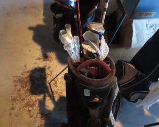 Three sets of golf clubs.