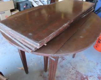 Drop leaf banquet table with multiple extra leaves.