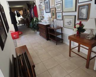 Framed art and antique chests, tables and tv trays.
