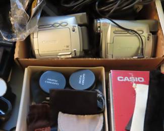 Two Canon camcorders, Gro pro attachments, tripods, selfie sticks, lenses.