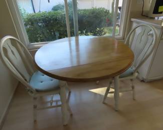 Drop leaf pine table and two chairs.