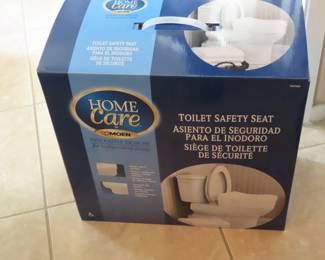 Brand new in box raised toilet seat.