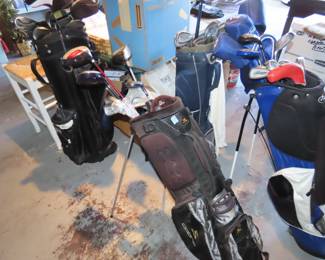 Three sets of golf clubs.