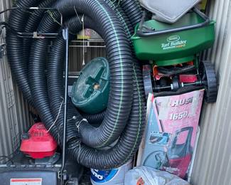 Yard equipment, lawnmower, seed spreader, water hoses, leaf blower.