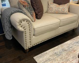 Fusion Furniture, Inc., Love seat with brass tack accents