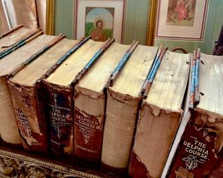 ANTIQUARIAN BOOKS HELD IN AN ANTIQUE FENDER-REPURPOSE AS A BOOK SHELF OR A PLANTER.  THE HANDIWORK IS FANTASTIC!