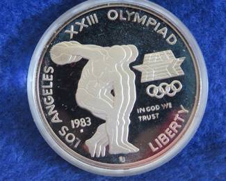 Lot 59. US Mint 1983 Olympic Silver Dollar containing 26.73 grams of 90% silver, COA and a display box