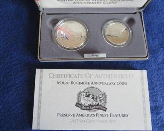 Lot 107. 1991 Mount Rushmore Anniversary Commemorative Two-Coin Proof Set including a 90% silver dollar, a clad half dollar, COA and an attractive display case