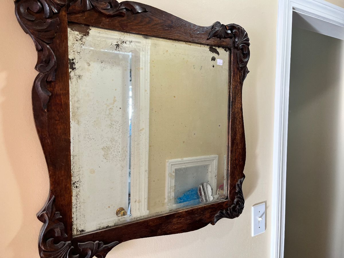 Ornate carved walnut framed mirror