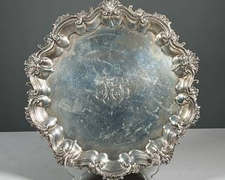 ANTIQUE HOWARD & CO. STERLING SILVER SALVER | With scrawl and acanthus leaf figured edge, raised on 3 feet, monogrammed29.49 ozt - dia. 12.5 in.
