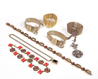 (8pc) MISC. ANTIQUE JEWELRY | Including a German carnelian and gold-tone necklace, signed (l. 15.5 in.), a red enameled link necklace, a book-form pendant necklace, a silver-tone fleur-de-lis locket pin, a pair of mesh bracelets, a 12K GF fine woven mesh bracelet, and a bracelet with tassels and purple faceted glass.
