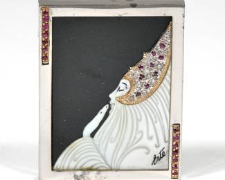 ROMAIN (ERTE) DE TIRTOFF (1892-1990) STERLING & GOLD BROOCH | From an edition of 250, designed as a carved mother of pearl woman in profile with a headdress of gold mounting diamonds and rubies and signed "Erte"; marked "? CFA STERLING 14K 62/250"
2 in., 31.8g
