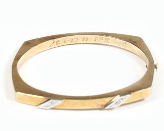 SPANISH 14K GOLD HINGED HARD BRACELET | having two platinum plaques mounted with melee diamonds engraved "SC 6-27-86 JFK" and marked "Spain 14k". 9.4g, dia. 2.25 in. (interior)

