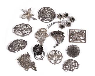 (13pc) STERLING FLOWER PINS | Sterling silver flower-shaped brooches and pins, each marked or tested to sterling, including: a Paglia Designed circular pin, a Coro pin with five flowers, a pin with marcasite, and others; total weight 6.75 ozt  - h. 3.75 in. (largest)
