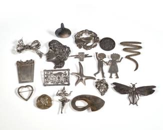 (17pc) STERLING SILVER PINS & MISC | Pins and brooches marked (or tested to) sterling silver, including: a sterling and 14k yellow gold pin, a 950 silver miniature bottle with inlaid metal wirework, a Georg Jensen style dove pin, a pin designed as a man and woman olding hands marked "ES 92", a starfish, a bow, two female busts, a heart shaped pin with marcasite, and others; total weight 6.84 ozt
