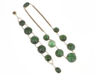 (2pc) CHINESE CARVED GREEN TOURMALINE, PEARL & GOLD JEWELRY | Comprising a necklace having seven round graduated carved green tourmaline links (22.0 - 22.4 x 11 mm, largest) set in 14k gold separated by chains with seed pearls, and with lengths of 14k gold chain terminating in a carved tourmaline mounted clasp (15.25, 40.4g); and a matching bracelet with five graduated carved tourmaline links (20.4 - 21.5 x 9.3 mm., largest) and a tourmaline mounted clasp (7.25 in., 29.1g)

