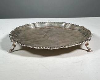 STERLING SILVER SALVER | Gadrooned edge decoration, raised on 3 feet, marked "sterling / 2395 /10 inch reproduction / 1765"21.04 ozt - h. 1.25 x dia. 10 in.
