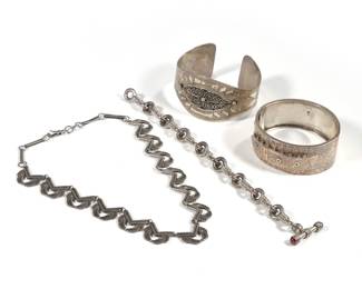 (4pc) STERLING BRACELETS & NECKLACE | Including an English engraved sterling silver belt-form hard bracelet with English hallmarks and makers mark "JM" (w. 2.25 in.), a cuff bracelet (w. 2.5 in.), a link bracelet with red cabochon clasp, and a Mexican sterling necklace (l. 13.5 in.); all together 4.70 ozt
