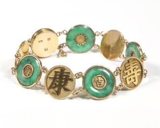 JADE & 18K GOLD CHINESE BRACELET | With alternating links of gold Chinese characters and gold mounted bi discs, marked "WN / 18" and with Chinese characters. 7 in., 19.0g
