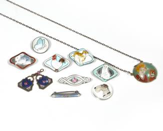 (11pc) MISC. ENAMEL JEWLEY | Including four diamond-shape enamel sterling animal pins, plus a butterfly pin, a rose pin, a bar-form lingerie pin with a purple flower, two enamel charms, and a necklace with intaglio painted person and cat, and a reverse intaglio dog.
