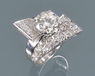 2.90CT ROUND BRILLIANT DIAMOND RING | Having a central 2.90-carat diamond [9.2 - 9.45 x 5.46 mm] prong set into a white gold screw attachment fitted white gold ring with tapering geometric plaques mounting well-matched melee diamonds
size 5, 10.3g
