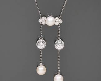 J.E. CALDWELL NATURAL PEARL & DIAMOND NECKLACE | Designed as central plaque mounting a natural button pearl flanked by six .20 ct full cut diamonds, the plaque suspending two chains - each with a single ~1.5 ct Old European Cut Diamond [left diamond; 1.45ct (6.9 - 6.8 x 4.7mm) / right diamond; 1.42ct (6.9 - 6.8 x 4.6 mm)] and a single natural button pearl. With original early 1900's Blue J.E. Caldwell Box. Accompanied by GIA Report No. 6224990716 describing the pearls as Natural Saltwater Pinctada pearls with no indications of treatment, Button shape, White & Light Cream color, overtones of Orient & Pink

