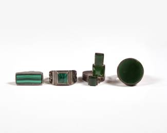 (4pc) STERLING RINGS | Including a malachite thunderbird ring, a ring with a bar of malachite, a ring with three semi-translucent green stones (not marked or tested), and a ring with a round semi-translucent stone; all together 1.37 ozt.
