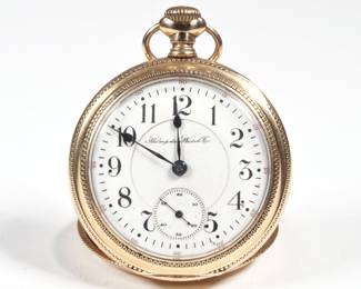 HAMPDEN DUEBER GOLD FILLED WATCH | Pocket watch having a gold-filled case with engraved steam engine train on the back, marked inside, "C.W.C. Co.", 21 jewel movement marked "The Dueber Watch Co. / Canton, O.", s/n 2160179, the face with Arabic numeral markers and a sub-seconds dial; dia. 1.25 in.
