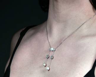 J.E. CALDWELL NATURAL PEARL & DIAMOND NECKLACE | Designed as central plaque mounting a natural button pearl flanked by six .20 ct full cut diamonds, the plaque suspending two chains - each with a single ~1.5 ct Old European Cut Diamond [left diamond; 1.45ct (6.9 - 6.8 x 4.7mm) / right diamond; 1.42ct (6.9 - 6.8 x 4.6 mm)] and a single natural button pearl. With original early 1900's Blue J.E. Caldwell Box