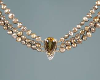 CITRINE, DIAMOND, & BAROQUE PEARL NECKLACE | Designed as a central 12.5 ct Pear Modified Brilliant Cut Citrine (21 x 12.7 x 10.4 mm) set in a conforming 14k gold surround mounting 9 near-colorless diamonds, suspended by three strands of non-bead cultured freshwater orangy-brown pearls (6.09 mm - 8.47mm); the clasp marked "14K'. Accompanied by GIA Report No. 42340885577 describing the pearls at Baroque, Orangy-Brown, Treated, non-bead cultured, Freshwater, Unionidae family, Modified color. l. 16 in.

