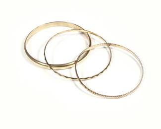 (3pc) 14K GOLD BRACELETS | Including a Hollow smooth gold bracelet, (10.9g), a twisted rope form bracelet (7.6g), and a textured call bracelet, 6.3g; total weight 24.9g - dia. 2.5 in. (interior)
