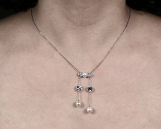 J.E. CALDWELL NATURAL PEARL & DIAMOND NECKLACE | Designed as central plaque mounting a natural button pearl flanked by six .20 ct full cut diamonds, the plaque suspending two chains - each with a single ~1.5 ct Old European Cut Diamond [left diamond; 1.45ct (6.9 - 6.8 x 4.7mm) / right diamond; 1.42ct (6.9 - 6.8 x 4.6 mm)] and a single natural button pearl. With original early 1900's Blue J.E. Caldwell Box